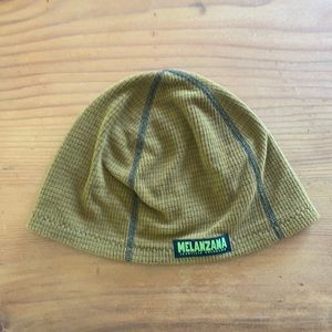 Melanzana yellow beanie. It’s a base-layer beanie that would fit under a hood.